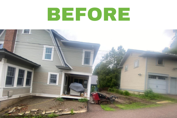 Before landscape renovation: A typical residential front yard in Burlington, Vermont, showing a bare and uneven area with old stone remnants, ready for transformation through custom patio installation, walkway design, and professional landscape construction.